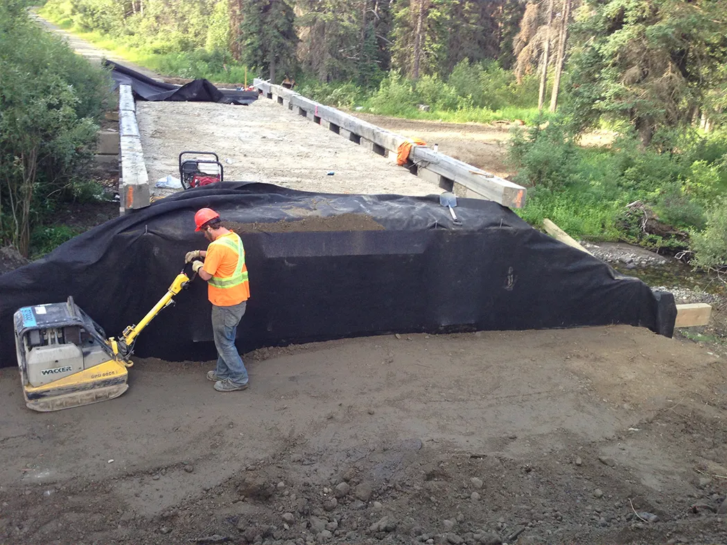 Team compacting on bridge worksite